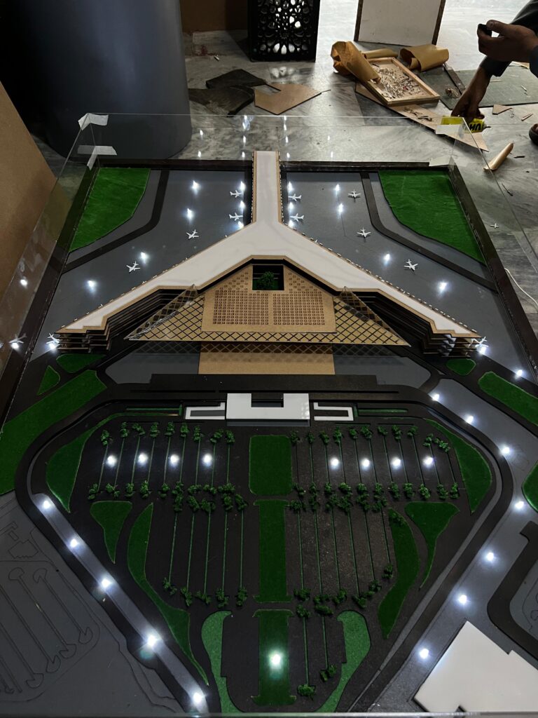 Top view of the Islamabad International Airport physical model showing the terminal roof, aircraft stands and landscaped car park