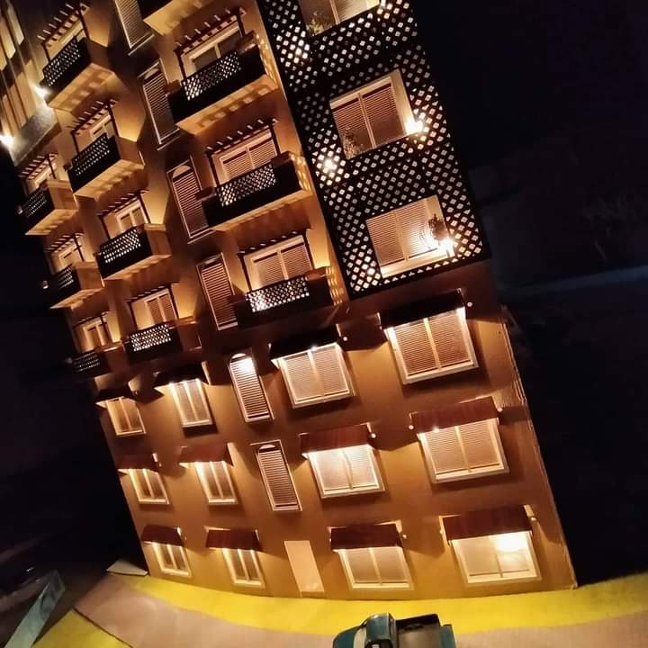 Upper floors of the Business Center model with lit balconies, window frames and perforated screen panels