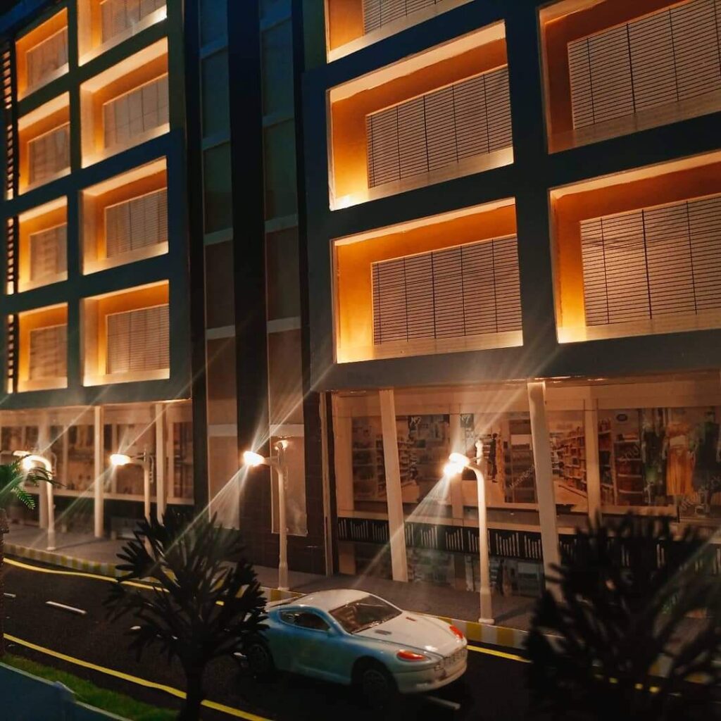 Close-up of the Business Center model showing ground-floor shops, street lights and the façade window frames
