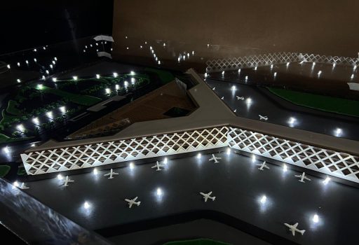 Physical scale model of the Islamabad International Airport terminal with its lattice façade, lit apron and model aircraft, made for FWO